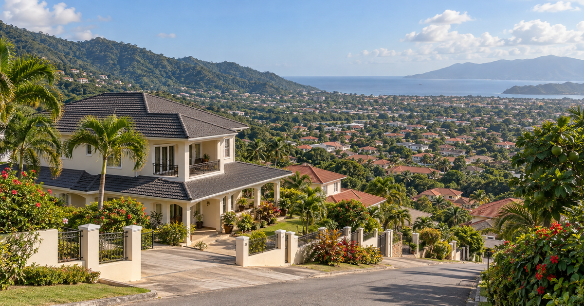 Hillside view over Diego Martin valley in northwest Trinidad with residential rooftops and the Gulf of Paria visible in the distance